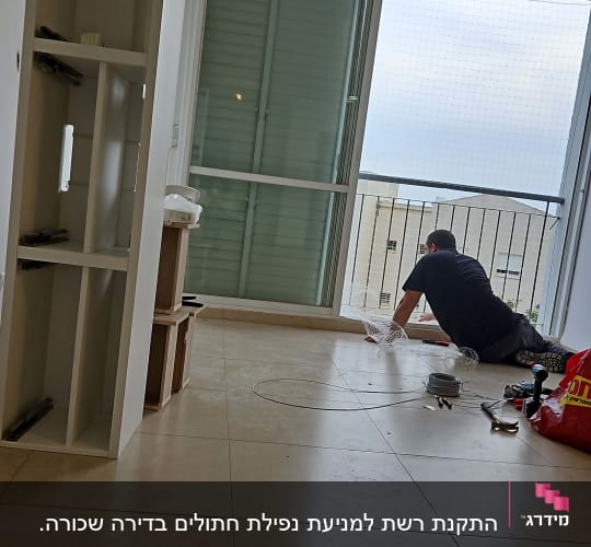 אדם מתקין רשת על חלון למניעת כניסת יונים